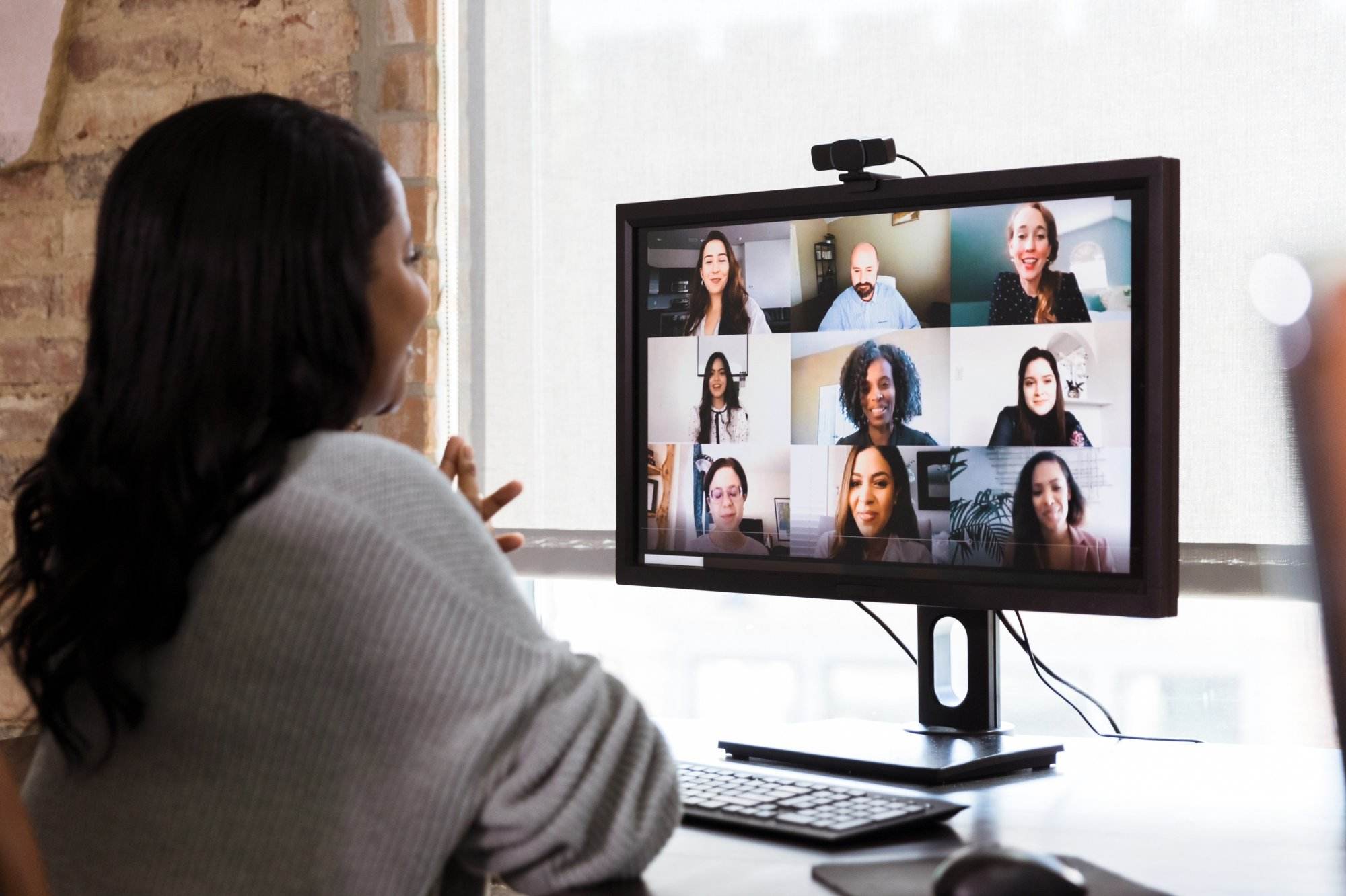 Multi-ethnic team has meeting via video conference online live meeting