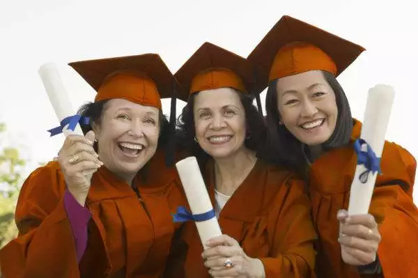 Smiling Graduates Holding Their Degrees Smiling Graduates Holding Their Degrees